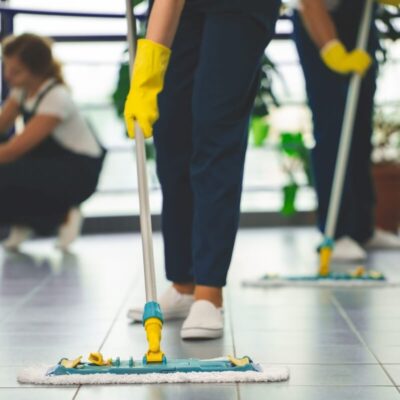 Profesjonalne sprzątanie w biurze z użyciem mopów i rękawic ochronnych.
